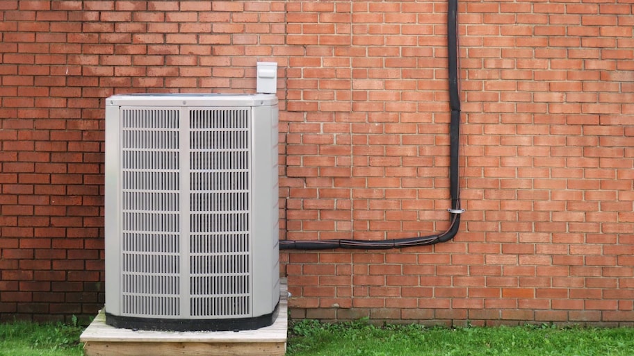 An AC next to a brick wall