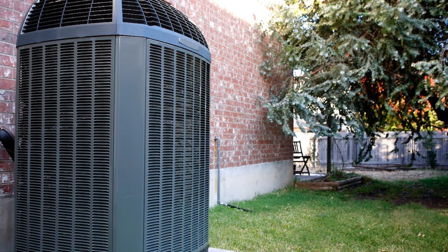 An AC system in the backyard of a house