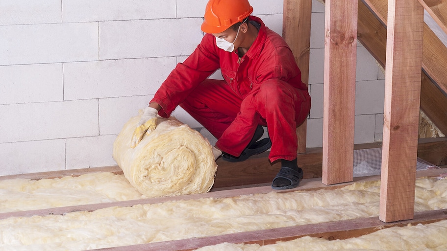 Batt and roll insulation installed by professional in protective gear