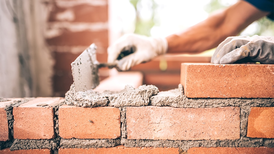 bricklayer building a new brick wall