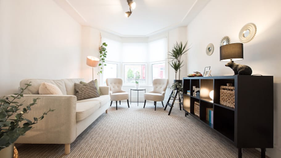 Bright living room with carpet and lounge chairs