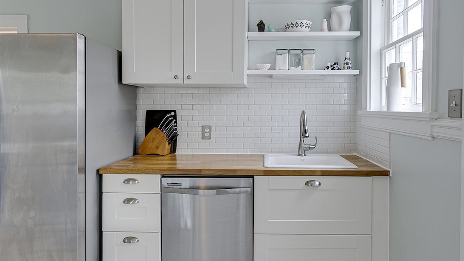 white and gray kitchen with butchers block countertop