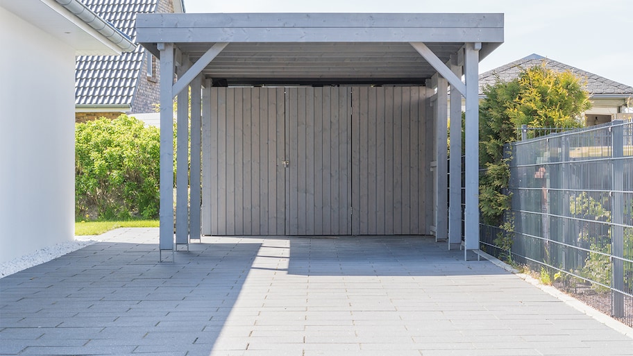 carport at the end of driveway next to house