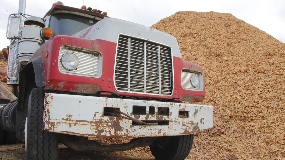 commercial truck delivering big pile of mulch