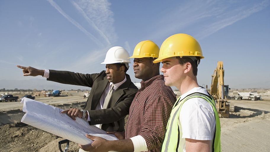 construction manager with two crew members on site