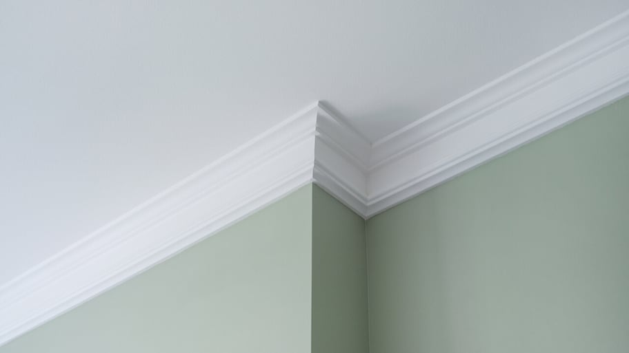 crown molding has been installed in a newly constructed room