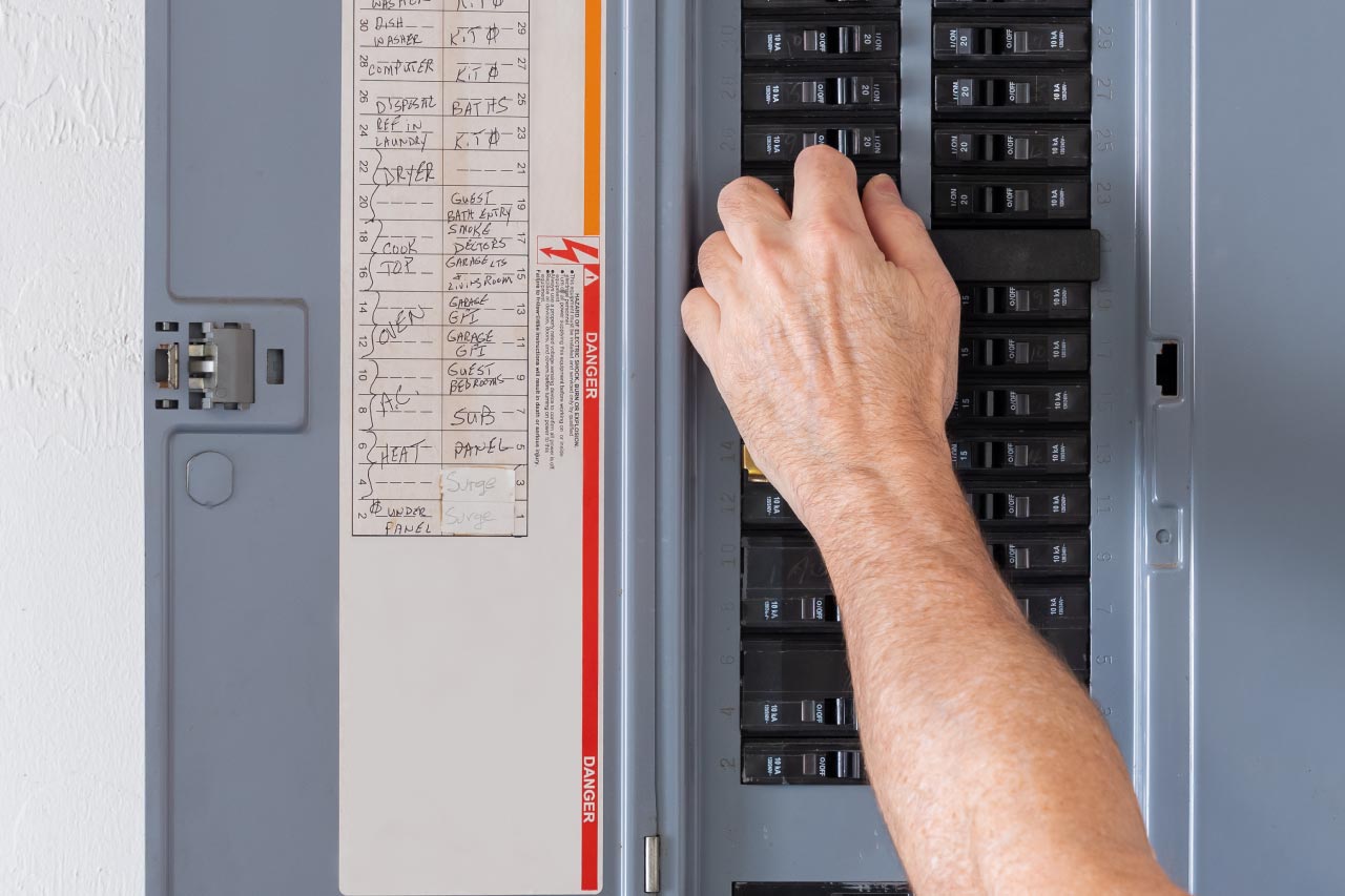 Electrician turning off power for electrical outlet