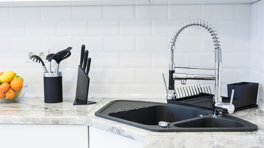 A fancy black sink in a modern kitchen