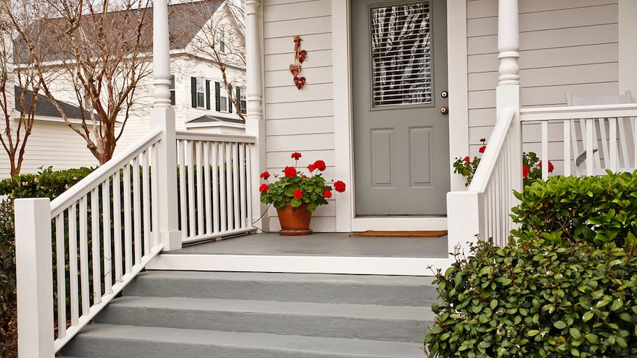 stairs and railings leading up to front entrance of home