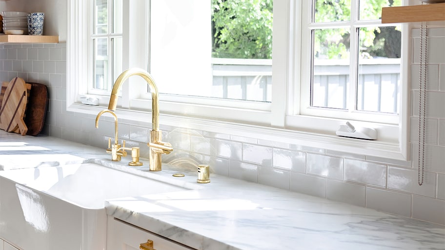 marble kitchen counter with gold faucet 