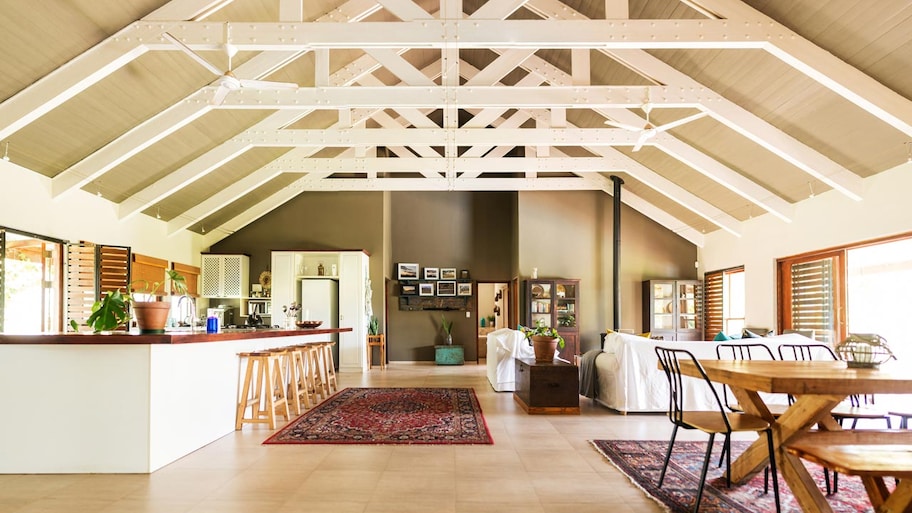 The interior open plan of a barndominium with vaulted ceilings