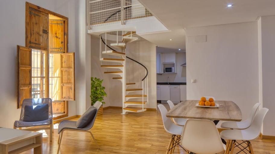 Interior of a dining room and stairs in a modern duplex