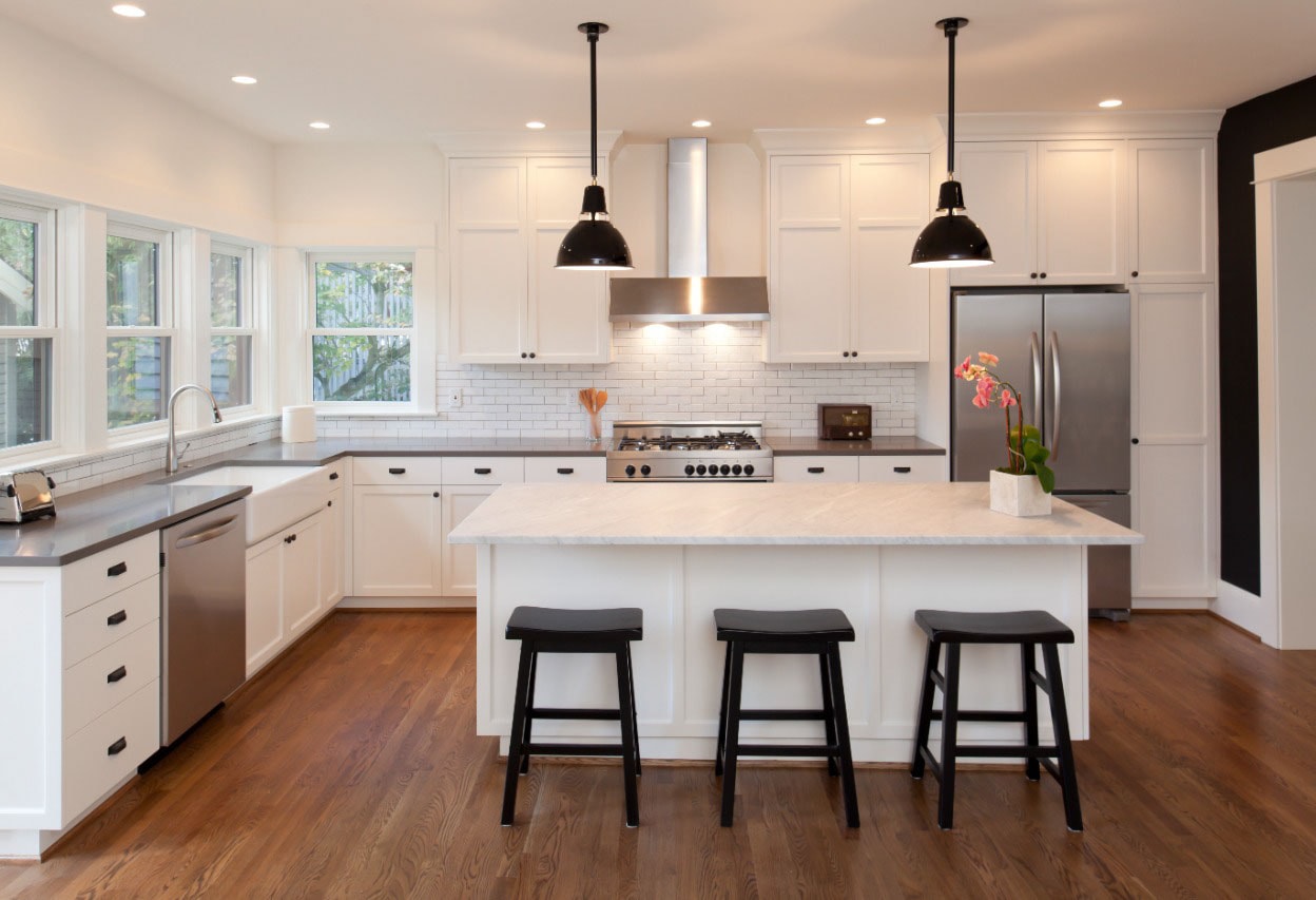 white kitchen with hardwood floors 