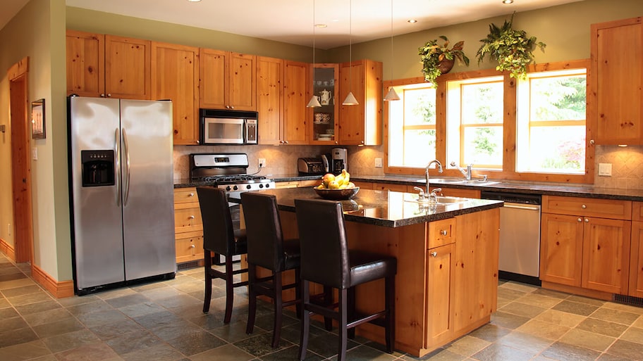 kitchen with slate floor tiles and pine cabinets