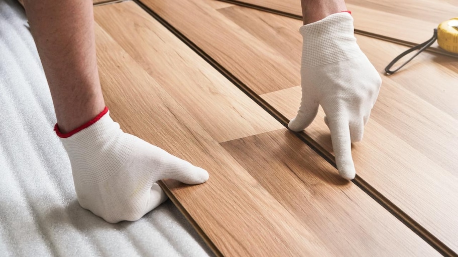 A man installing laminate floor