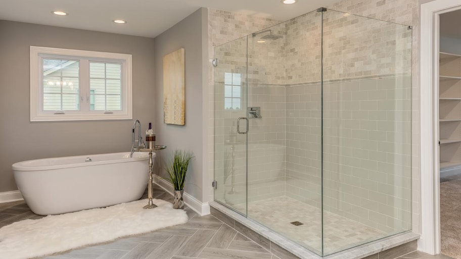 A master bathroom with a glass shower