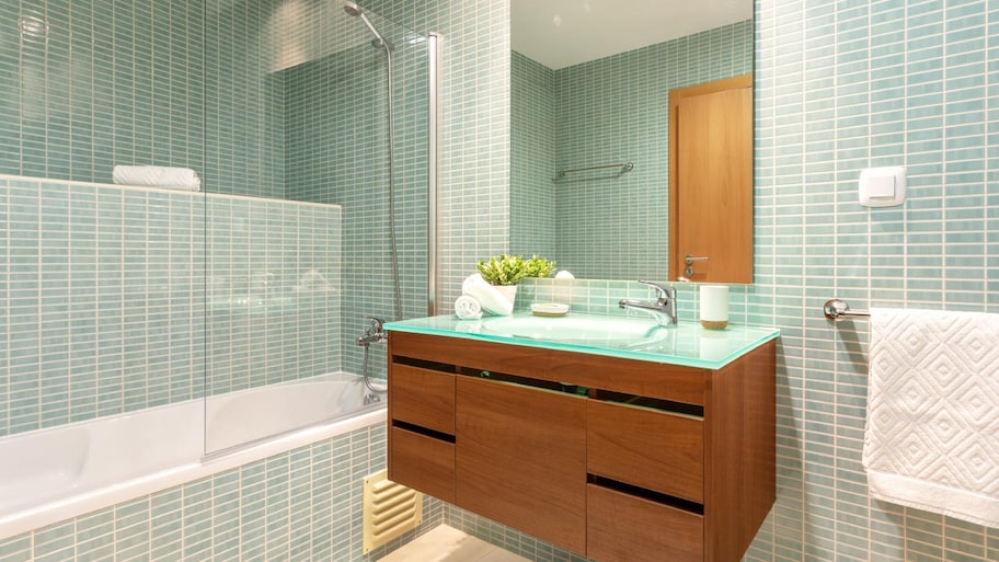 A modern bathroom with shower and washbasin