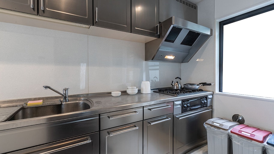 modern kitchen with stainless steel countertops and cabinets