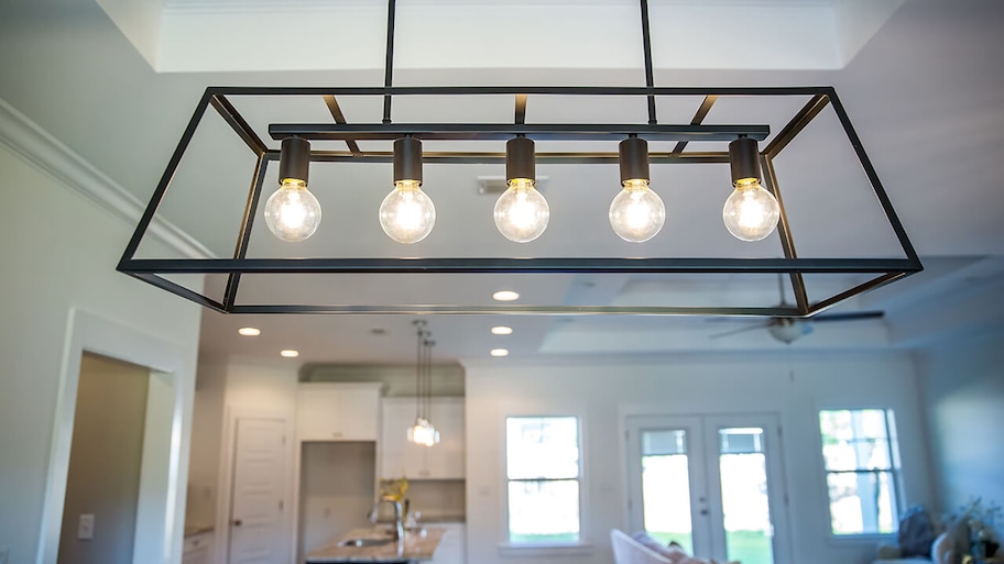 modern black metal lighting fixtures hanging in dining room