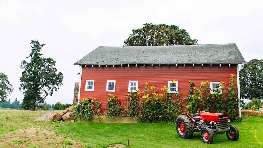 newly built barn on farm with tractor