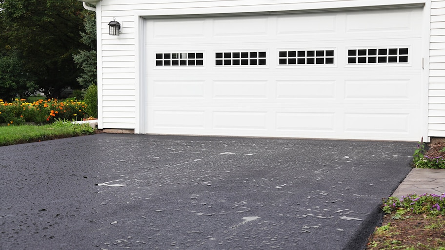 asphalt paved driveway in front of garage