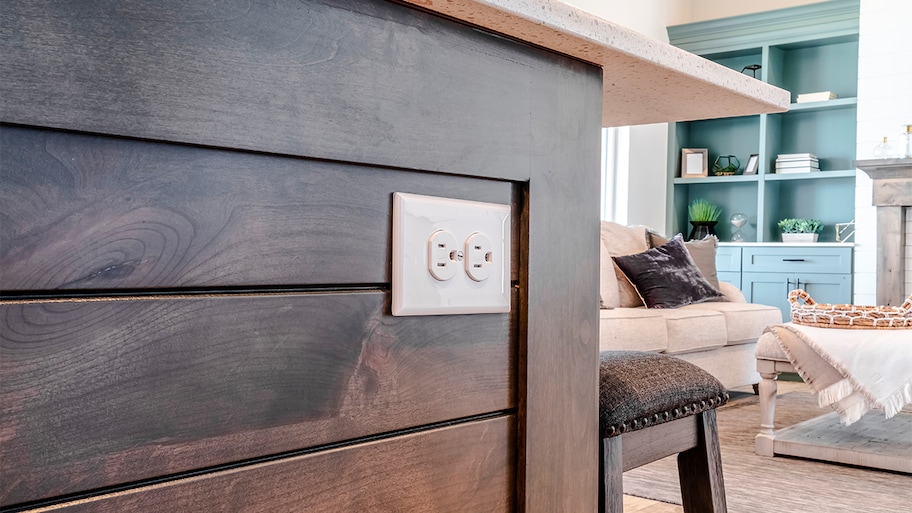 Electrical outlet with three slot receptacles installed on the kitchen island