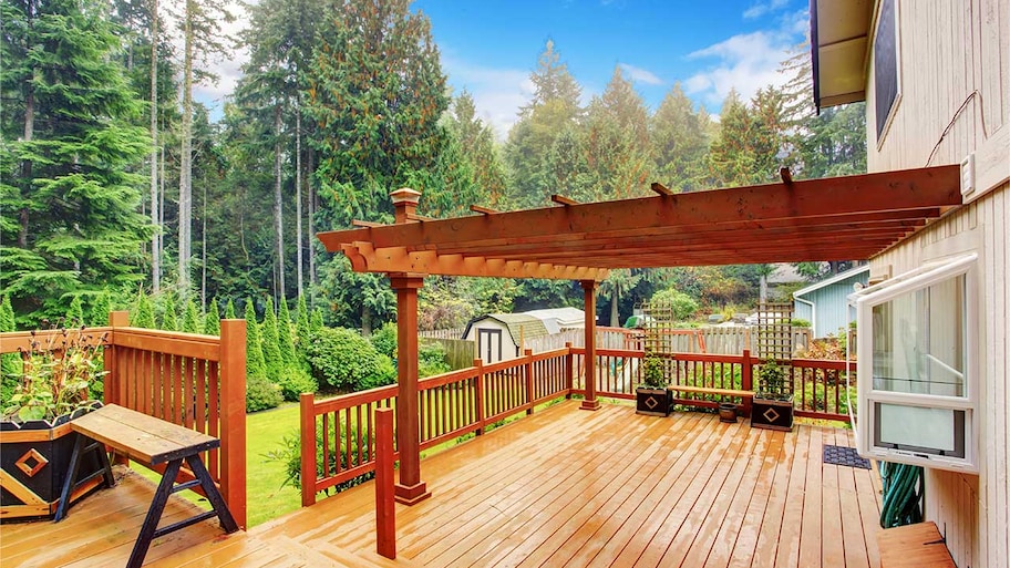 pergola built over a deck in backyard of house