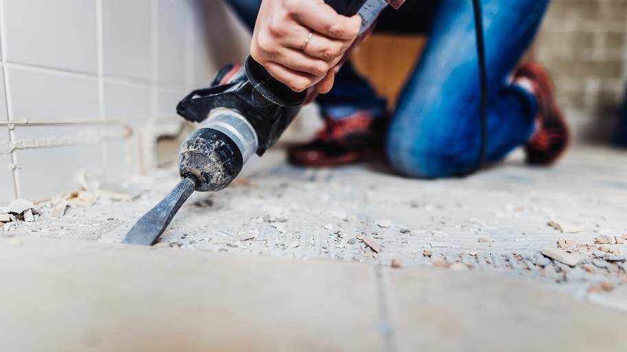 professional repairing damaged flooring in house