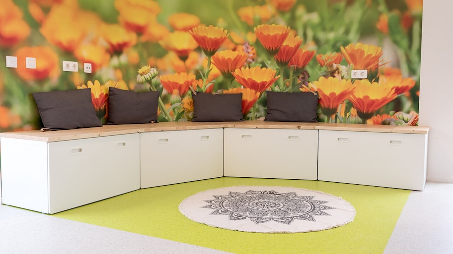 bright room with two color marmoleum flooring and flower mural