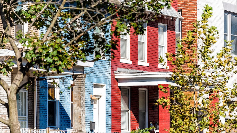 row of painted brick houses in urban neighborhood