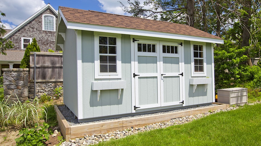 light blue shed in a backyard