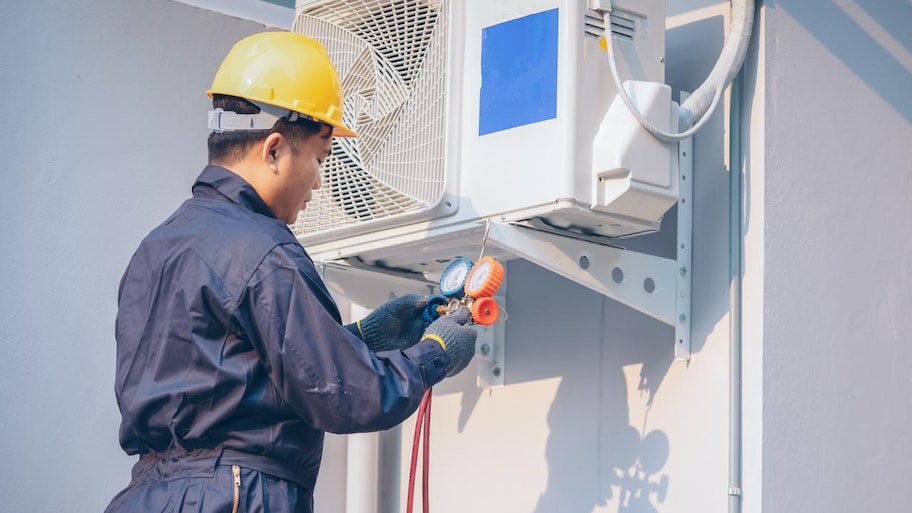 Technician checking AC condenser