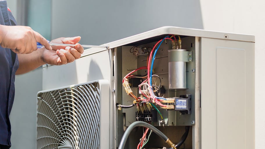 Technician repairing air conditioner