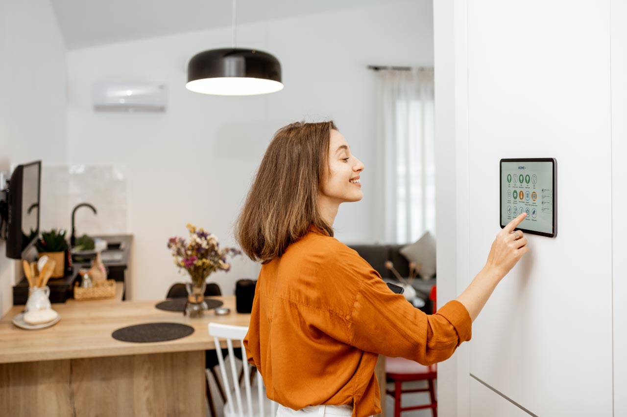 Woman controlling home with a digital touch screen