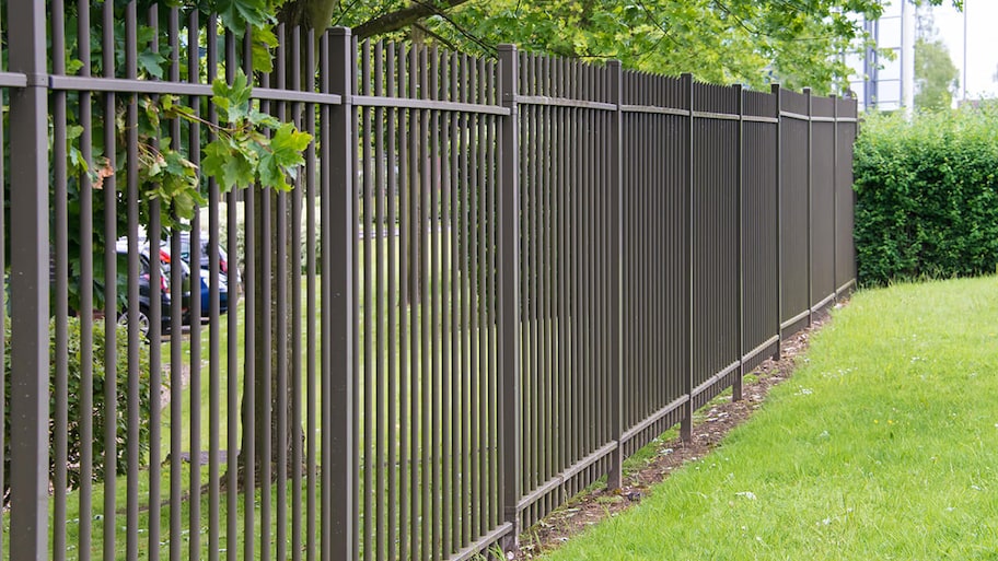 new wrought iron fence around yard of home